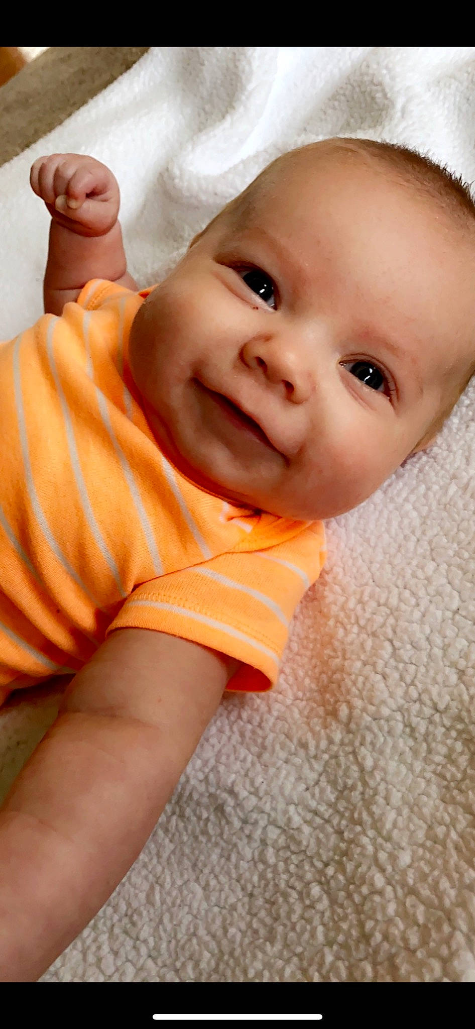 Finley is registered to the contest to win money with this photo: baby, cheek, child, chin, close_up, eye, face, facial_expression, finger, hand, head, lip, mouth, nose, orange, person, portrait_photography, skin, smile, toddler