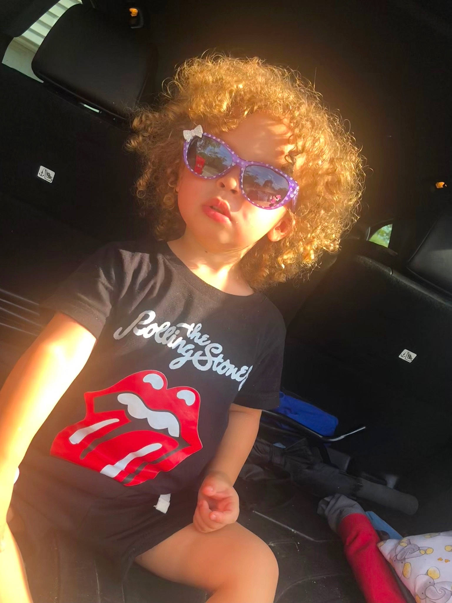 Zoe is registered to the contest to win money with this photo: automotive_exterior, elbow, entertainment, event, eyewear, flash_photography, fun, glasses, goggles, human_leg, leisure, magenta, mouth, person, shorts, smile, sunglasses, t_shirt, thigh, vehicle_door