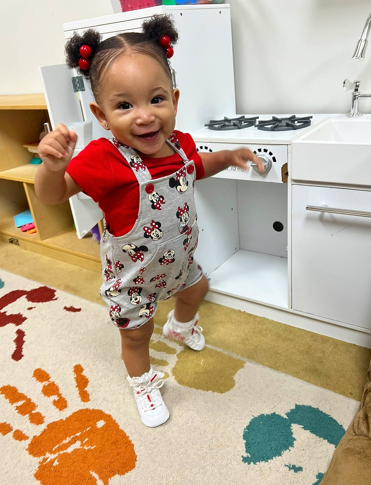 Amari is registered to the contest to win money with this photo: baby, baby_toddler_clothing, child, design, dress, face, floor, flooring, happy, human_leg, joy, pattern, person, room, shorts, skin, sleeve, smile, standing, t_shirt