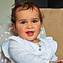 toddler, child, smiling, face, white_clothing, high_chair, indoors, cute, happy, portrait, baby, infant, person, seated, wooden_buttons, rosy_cheeks, brown_hair, home, furniture, closeup