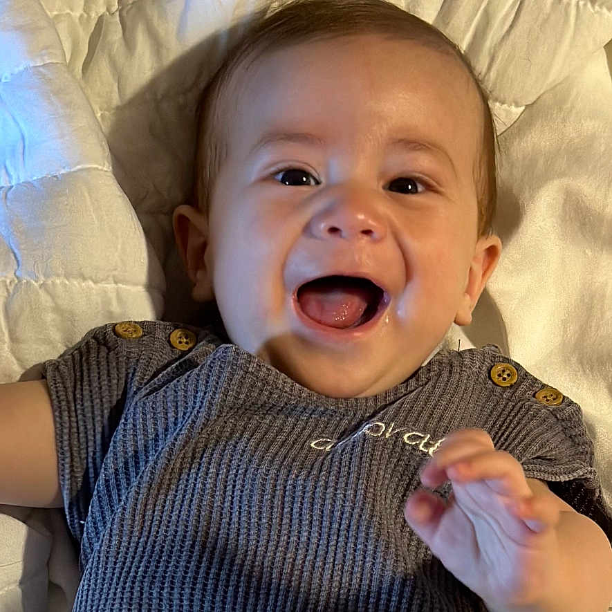Jax is registered to the contest to win money with this photo: baby, babylaughing, bodypart, couch, cutlery, face, finger, furniture, hand, happy, head, laughing, mouth, newborn, person, photography, portrait, smile, spoon, teeth