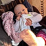 Inaya a rejoint le concours — aidez-le/la à gagner de superbes lots ! baby, blanket, sock, stroller, child, cozy, clothing, pink, white, fabric, hand, face, smile, seatbelt, sunlight, shadow, cute, portrait, infant, warm