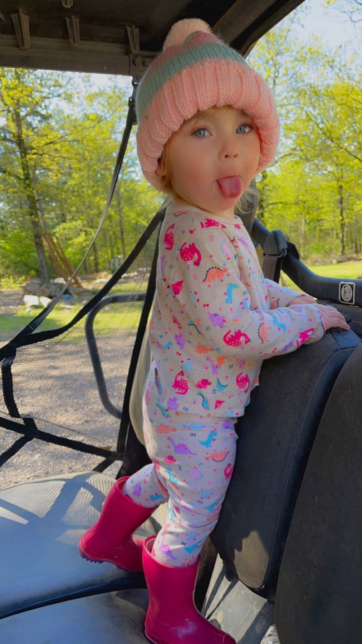 Tatum joined the competition — help win amazing prizes! baby_toddler_clothing, cap, child, fashion_accessory, fun, grass, headwear, leisure, magenta, outdoor_play_equipment, pattern, person, pink, play, recreation, sitting, sleeve, surprise, toddler, toy