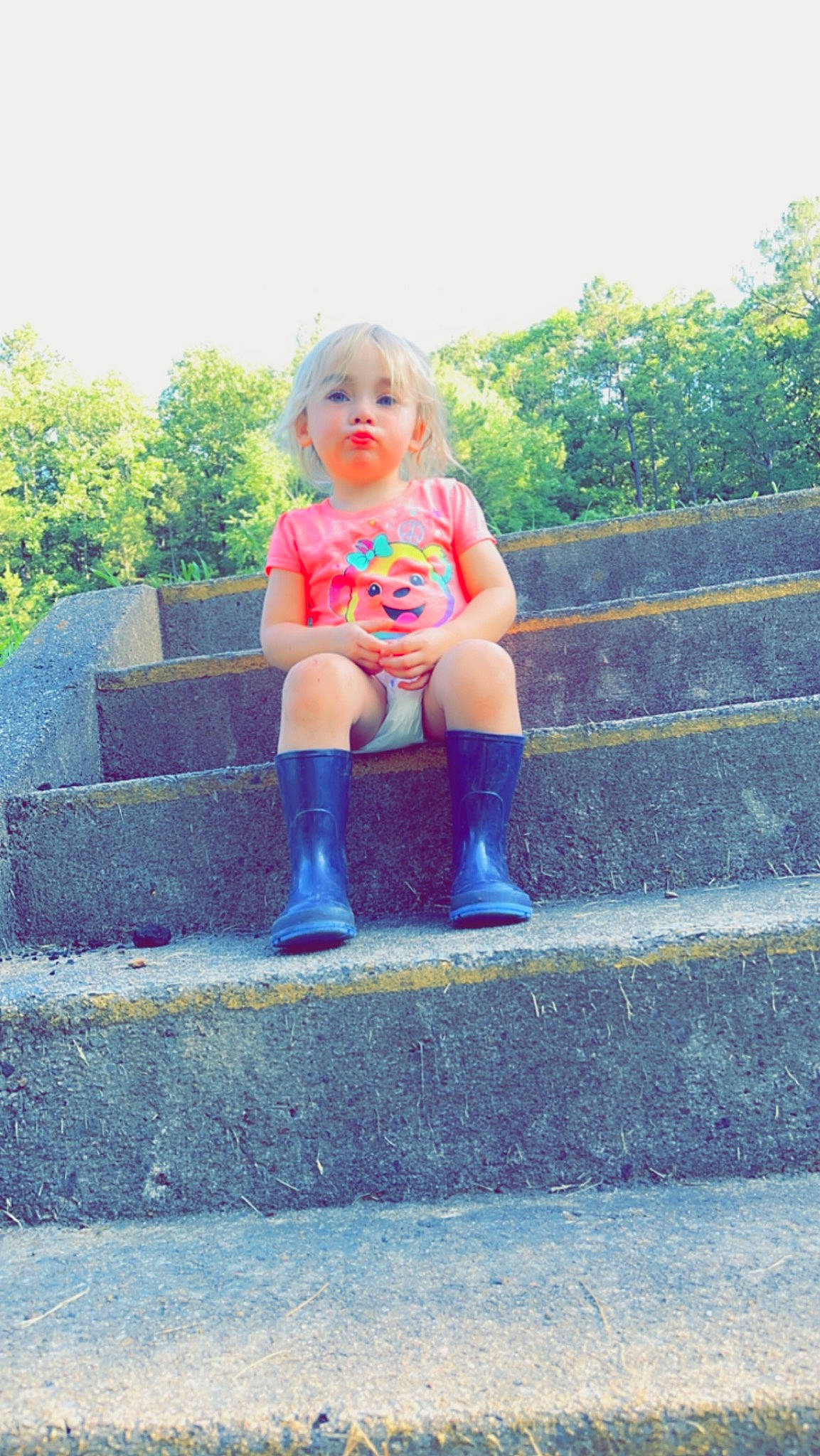 Tatum is registered to the contest to win money with this photo: asphalt, denim, dress, electric_blue, eye, foot, fun, grass, happy, human_body, human_leg, knee, leg, leisure, person, plant, recreation, sitting, thigh, toddler