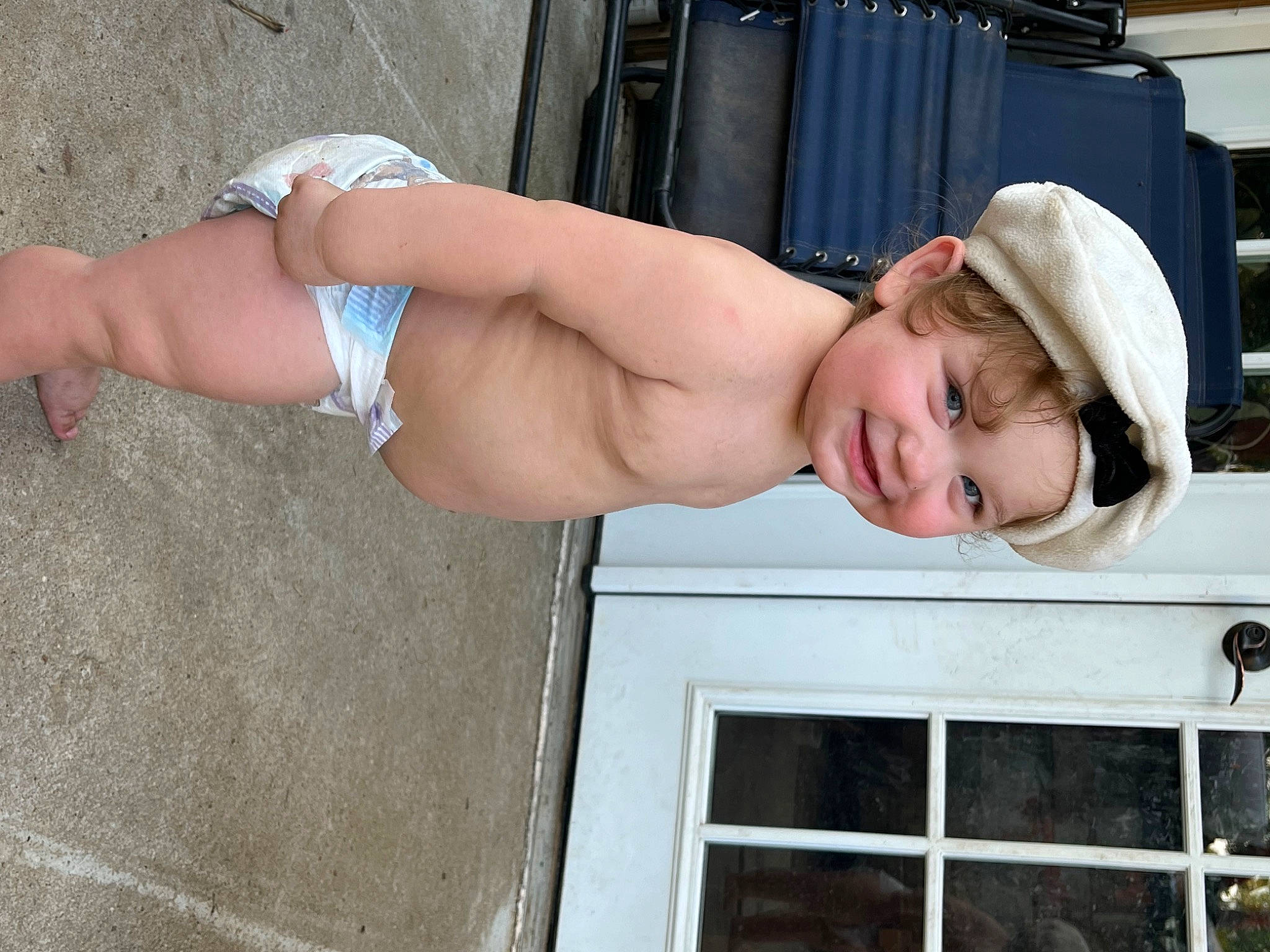 Harper is registered to the contest to win money with this photo: abdomen, barechested, calf, cap, chest, elbow, electric_blue, eyewear, hat, headwear, house, human_leg, joy, knee, muscle, navel, person, stomach, thigh, trunk