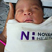 Je'Riah joined the competition — help win amazing prizes! newborn, baby, sleeping, swaddled, hand, bracelet, cloth, logo, purple, white, face, infant, peaceful, portrait, closeup, person, care, health, tender, wrapped