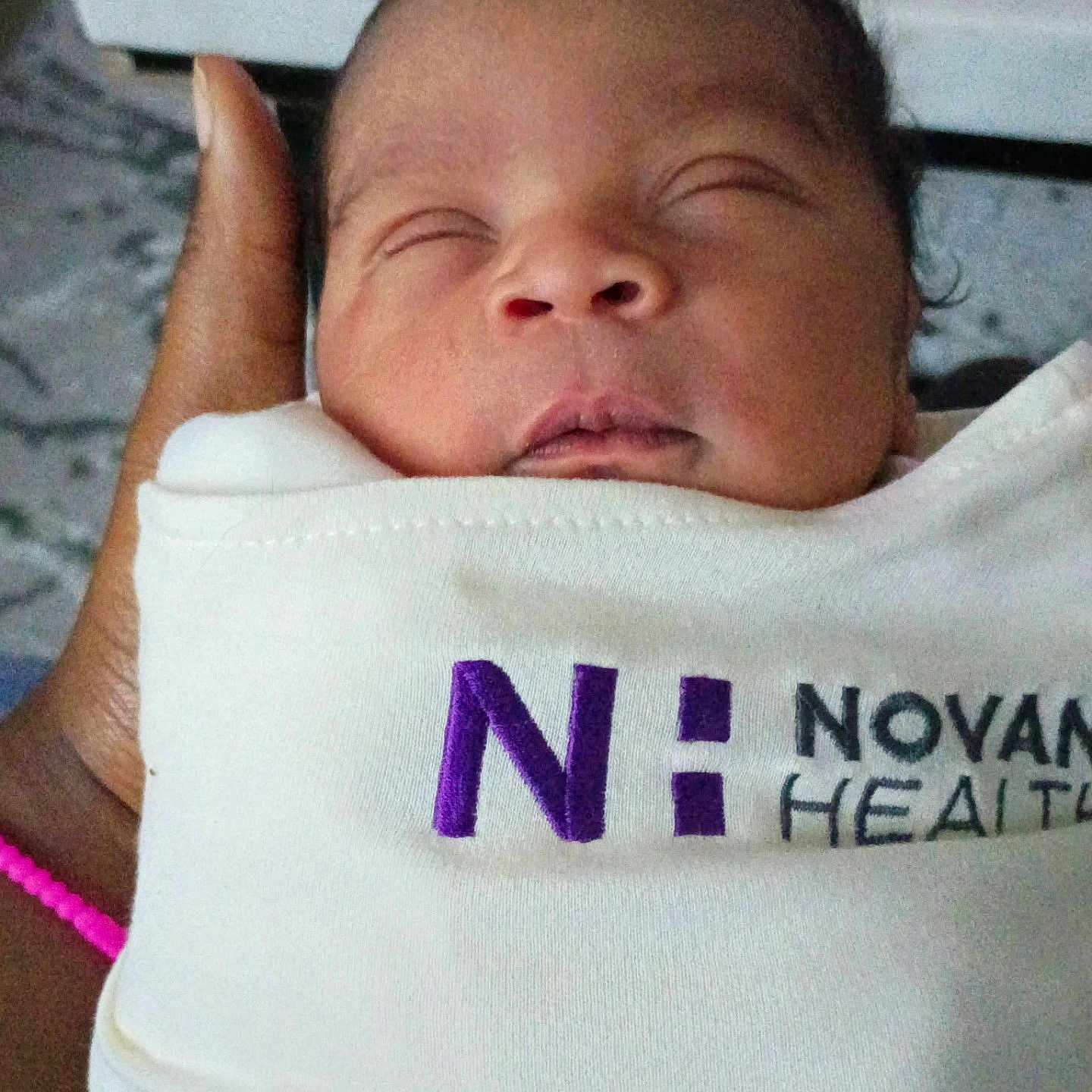 Je'Riah joined the competition — help win amazing prizes! newborn, baby, sleeping, swaddled, hand, bracelet, cloth, logo, purple, white, face, infant, peaceful, portrait, closeup, person, care, health, tender, wrapped