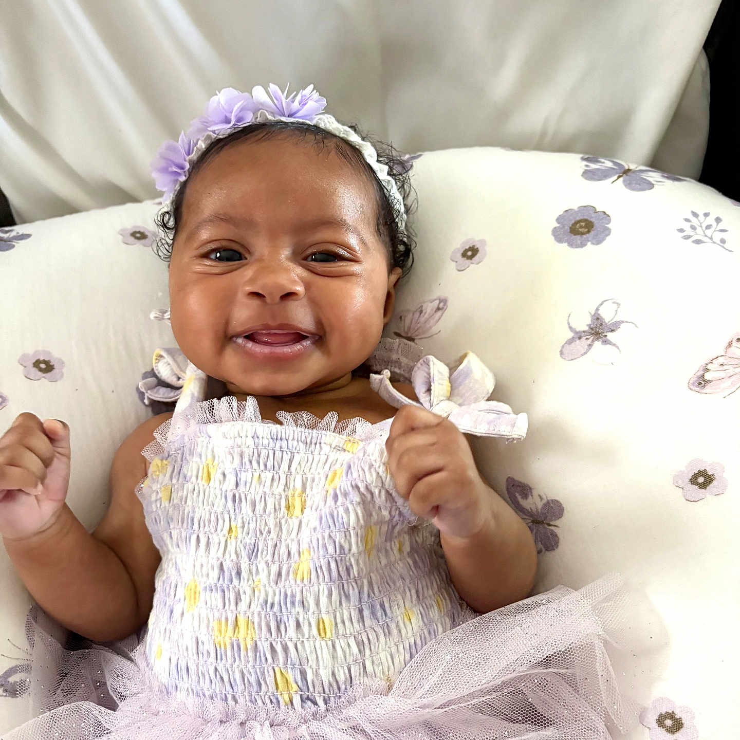 Ekho joined the competition — help win amazing prizes! baby, child, cushion, cute, dress, flower, hand, happy, headband, indoors, infant, lying_down, pattern, person, portrait, purple, skin, smiling, toddler, tutu
