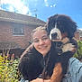 Bilbo joined the competition — help win amazing prizes! bernese_mountain_dog, braided_hair, casual_clothing, daytime, dog, flowers, garden, greenery, happy, house, nature, outdoor, pet, portrait, puppy, sky, smiling, sunny, walking_path, woman
