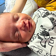 Kaylyn joined the competition — help win amazing prizes! baby, newborn, sleeping, hand, blanket, animal_print, yellow_shirt, closeup, indoor, comfort, peaceful, face, skin, person, caring, rest, infant, portrait, cozy, tender