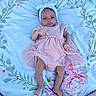 Kaylyn is registered to the contest to win money with this photo: baby, infant, newborn, pink_dress, headband, blanket, floral_pattern, soft_texture, lying_down, small_hands, small_feet, curious_expression, pastel_colors, cozy, indoors, portrait, child, cute, adorable, person