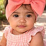 adorable, baby, blurred_background, bow, brown_eyes, cheeks, closeup, dress, earring, eyelashes, fashion, gingham, headband, outdoor, pink, portrait, sitting, skin, smile, toddler