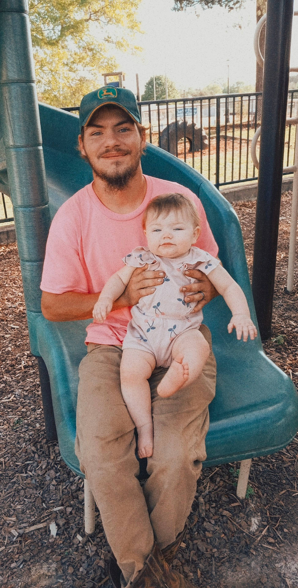 Carlei joined the competition — help win amazing prizes! baby, clothing, eye, face, facial_expression, grass, happy, hat, head, headwear, human_body, interaction, joy, lap, leaf, leisure, person, pink, plant, shorts