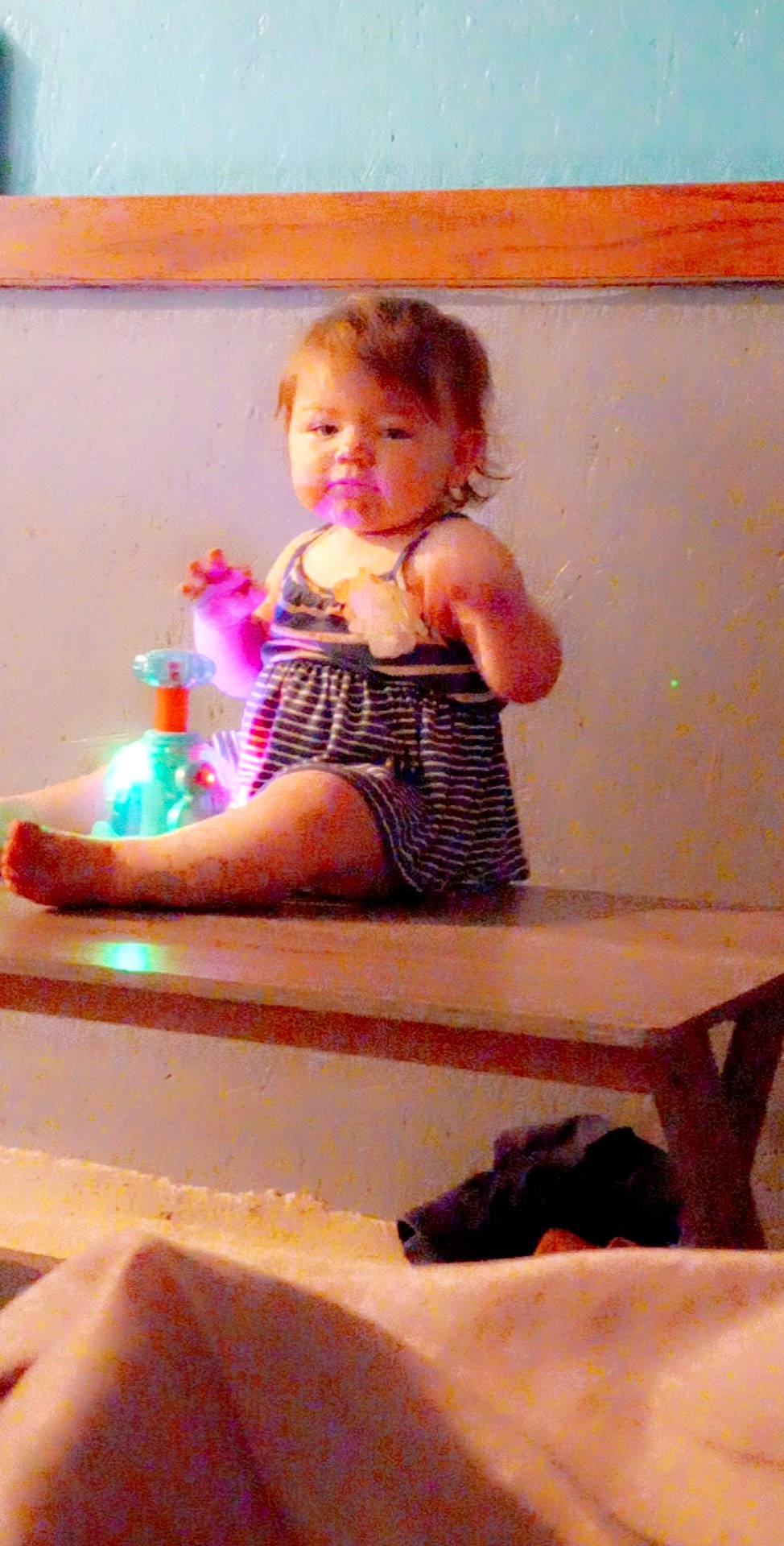 Carlei is registered to the contest to win money with this photo: baby_toddler_clothing, bathing, chair, child, finger, fun, hair, hand, head, human_leg, magenta, person, pink, play, room, sitting, smile, stairs, thigh, toddler