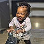 baby, child, clothing, cute, earrings, furniture, glass_table, hair, happy, home, indoor, joyful, pacifier, person, playful, reflection, smiling, standing, twists, young