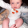 baby, infant, onesie, pumpkin, tattoo, arm, leg, foot, toe, skin, person, holding, clothing, cute, indoors, closeup, portrait, child, newborn, white