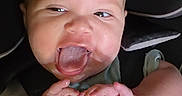 Zachariah is registered to the contest to win money with this photo: baby, infant, car_seat, child, cute, hands, face, tongue, smiling, straps, seatbelt, close_up, expression, playful, happy, indoors, person, childhood, head, young