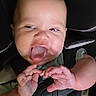 baby, infant, car_seat, child, cute, hands, face, tongue, smiling, straps, seatbelt, close_up, expression, playful, happy, indoors, person, childhood, head, young
