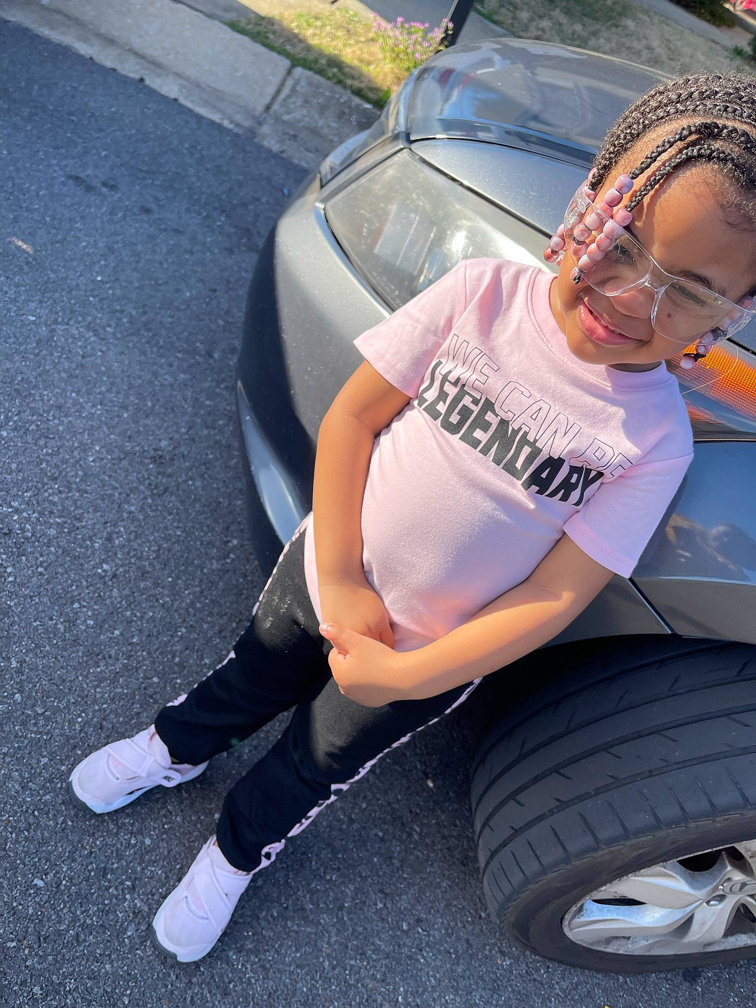 Chloe Nevaeh joined the competition — help win amazing prizes! alloy_wheel, automotive_design, automotive_exterior, automotive_lighting, automotive_tire, bumper, car, hood, hubcap, human_body, joy, land_vehicle, leg, motor_vehicle, person, shorts, synthetic_rubber, tire, tread, vehicle