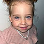 toddler, child, smile, blue_eyes, hair_buns, pink_sweater, necklace, portrait, face, cute, happy, indoors, young_child, fashion, closeup, person, eyelashes, skin, childhood, warm_clothing