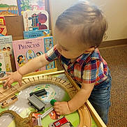 Arlen is registered to the contest to win money with this photo: animal, bodypart, boy, chair, child, clothing, dinosaur, face, finger, furniture, hand, head, machine, male, pants, person, photography, portrait, wheel, wood