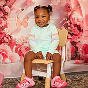 Olivia joined the competition — help win amazing prizes! toddler, child, smiling, pigtails, chair, pink_shoes, pastel_clothing, indoor, portrait, flower_backdrop, butterflies, happy, cute, baby, sitting, colorful, playful, young_child, decorative, fun