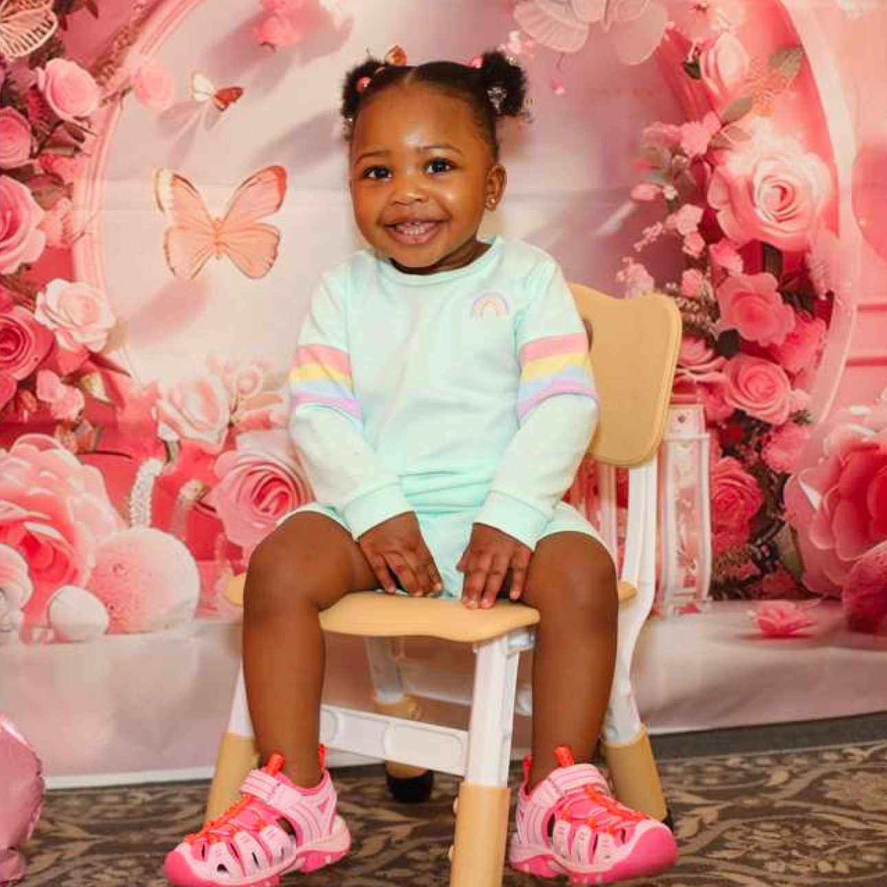 Olivia joined the competition — help win amazing prizes! toddler, child, smiling, pigtails, chair, pink_shoes, pastel_clothing, indoor, portrait, flower_backdrop, butterflies, happy, cute, baby, sitting, colorful, playful, young_child, decorative, fun