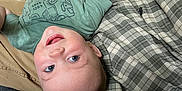 William joined the competition — help win amazing prizes! adult, baby, blue_eyes, casual, cheerful, child, clothing, couch, face, hand, happy, indoor, infant, person, plaid_shirt, relaxed, short_hair, skin, smiling, upside_down