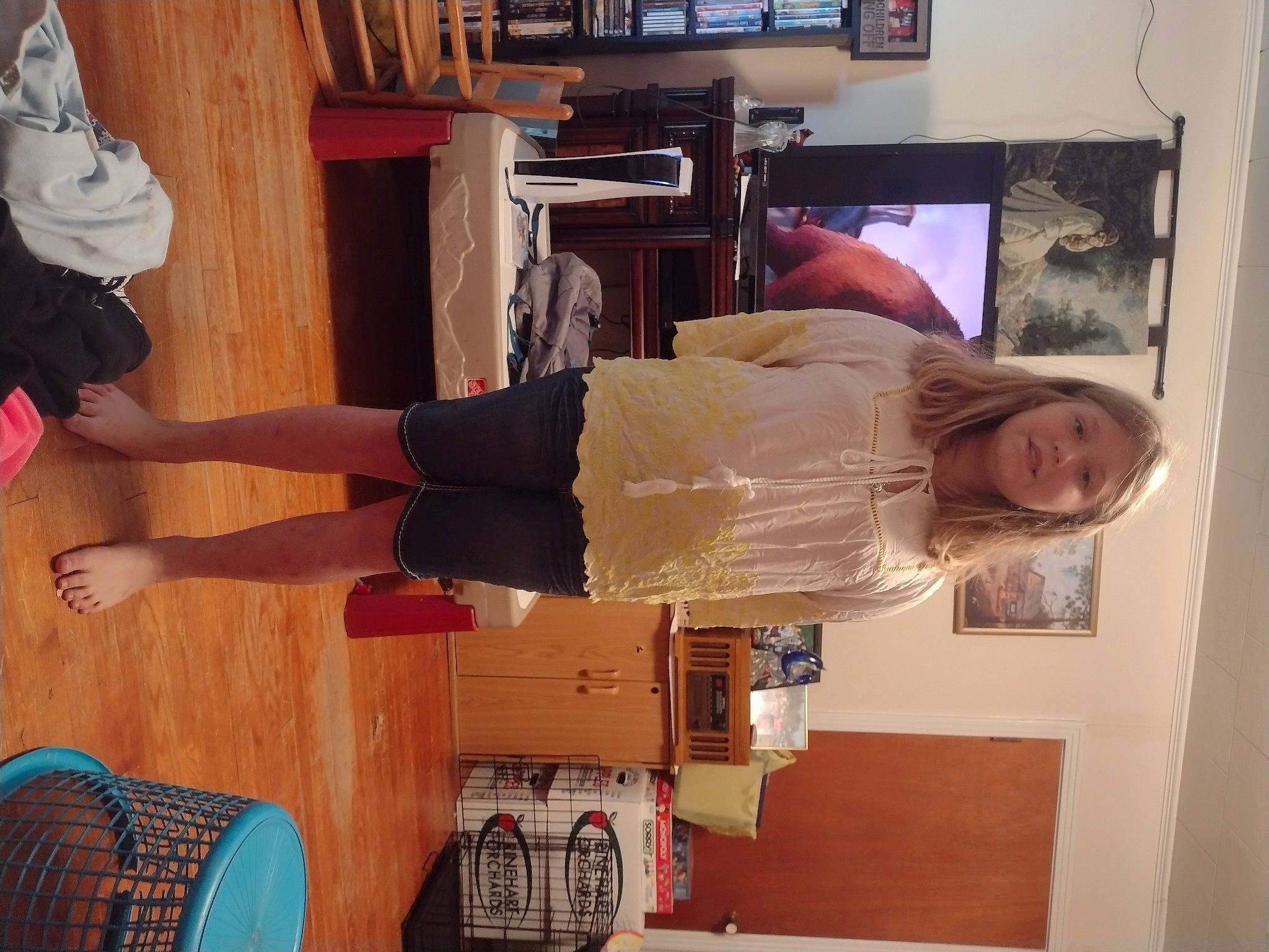 Paisley joined the competition — help win amazing prizes! balance, comfort, flooring, hardwood, hat, human_leg, joint, knee, leg, person, picture_frame, room, shelf, shelving, shorts, smile, thigh, varnish, waist, wood