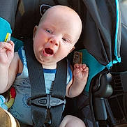 Taison is registered to the contest to win money with this photo: baby, child, car_seat, seatbelt, blue_eyes, expression, safety, infant, clothing, cute, car_interior, sunlight, seat, straps, head, arms, legs, skin, transportation, toddler