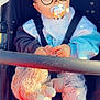 baby, child, stroller, pacifier, plush_toy, clothing, glasses_filter, bear_ears_filter, heart_effects, cute, sitting, comfort, straps, footwear, pants, jacket, toy, indoors, portrait, person