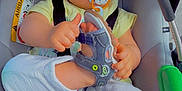 Timéo a rejoint le concours — aidez-le/la à gagner de superbes lots ! baby, child, car_seat, pacifier, sandal, footwear, white_pants, yellow_shirt, seatbelt, car_accessory, cute, infant, indoors, playful, face_filter, cat_ears, small_child, holding, sitting, straps