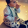 Timéo participe au concours pour gagner de l'argent avec cette photo : child, toddler, baby, sitting, floor, snack, clothing, bib, shoes, glasses_filter, bear_ears_filter, hearts, indoors, playful, cute, portrait, young_child, munching, casual, fun
