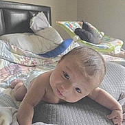 Loretto is registered to the contest to win money with this photo: baby, bed, blanket, child, comfort, cozy, cute, face, head, indoors, infant, person, pillow, rest, skin, sleeping_area, smile, soft, tummy_time, young