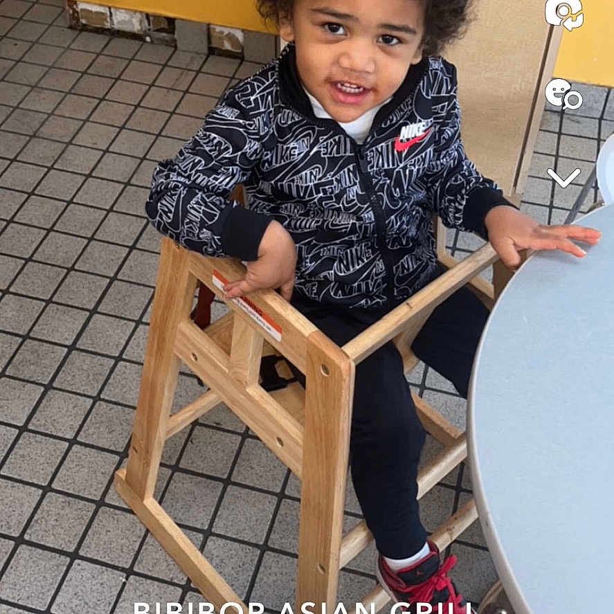Kyle is registered to the contest to win money with this photo: barstool, bodypart, boy, chair, child, clothing, face, finger, footwear, furniture, hand, head, indoors, interiordesign, male, person, photography, portrait, shoe, sitting