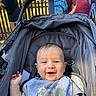 Logan joined the competition — help win amazing prizes! animal_print, baby, bib, casual, child, clothing, cute, daylight, face, fence, happy, infant, outdoor, people, portrait, seat, smiling, stroller, sunlight, young_child