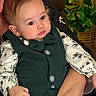 adult, baby, bow_tie, brown, child, clothing, cute, expression, face, fashion, green, hand, indoor, person, plant, portrait, seated, shirt, toddler, vest