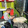 Hope a rejoint le concours — aidez-le/la à gagner de superbes lots ! animal, blue_sky, child, curly_hair, daylight, deck, dog, footwear, grass, outdoor, pet, plants, playhouse, playing, summer, sunlight, toddler, toy, tricycle, white_dress