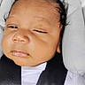 baby, car_seat, child, closeup, clothing, expression, face, harness, head, indoors, infant, newborn, one_eye_closed, padded_cushion, person, safety, seatbelt, skin, transport, white_shirt