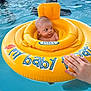 baby, baby_float, child, cute, floating, hand, infant, inflatable, outdoor, person, playful, pool, recreation, safety, sitting, splash, summer, swimming, water, yellow