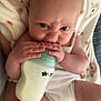 Willow is registered to the contest to win money with this photo: baby, infant, bottle, milk, blanket, bear_pattern, clothing, skin, hand, face, expression, eyes, mouth, fingers, legs, torso, indoor, person, cute, feeding