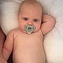 Willow is registered to the contest to win money with this photo: baby, infant, pacifier, diaper, cushion, skin, face, eyes, arm, hand, torso, lying_down, comfort, cute, soft, relaxing, child, indoors, portrait, young