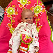 Autumn joined the competition — help win amazing prizes! baby, infant, child, smile, pajamas, cherry_print, baby_chair, flower_pattern, colorful, indoors, wood_paneling, comfort, cute, young, playful, pacifier, striped, fabric, seated, happy