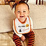 baby, bib, black, child, costume, couch, cute, festive, halloween, happy, headband, holiday, indoors, orange, portrait, pumpkin, sitting, smiling, striped_tights, toddler