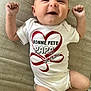 Chloë a rejoint le concours — aidez-le/la à gagner de superbes lots ! baby, beige_background, celebration, closeup, clothing, cute, expression, face, french_text, happy, infant, joy, lying_down, onesie, person, raised_fists, red_heart, skin, smile, text