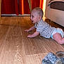 baby, crawling, striped_shirt, diaper, wooden_floor, table, orange_curtains, slippers, indoor, child, flooring, furniture, person, head, happy, side_view, home, cute, infant, smiling
