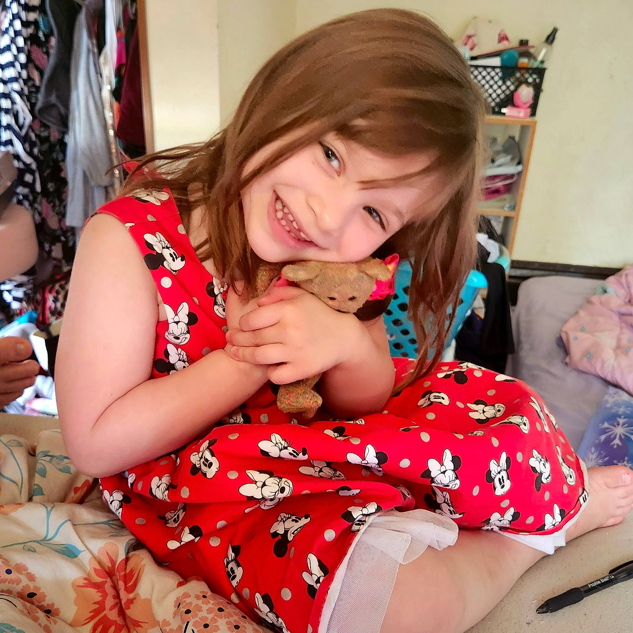 Mya is registered to the contest to win money with this photo: arm, child, comfort, event, facial_expression, finger, fun, hairstyle, happy, human_leg, joy, knee, lap, pattern, person, pink, sitting, sleeve, smile, thigh