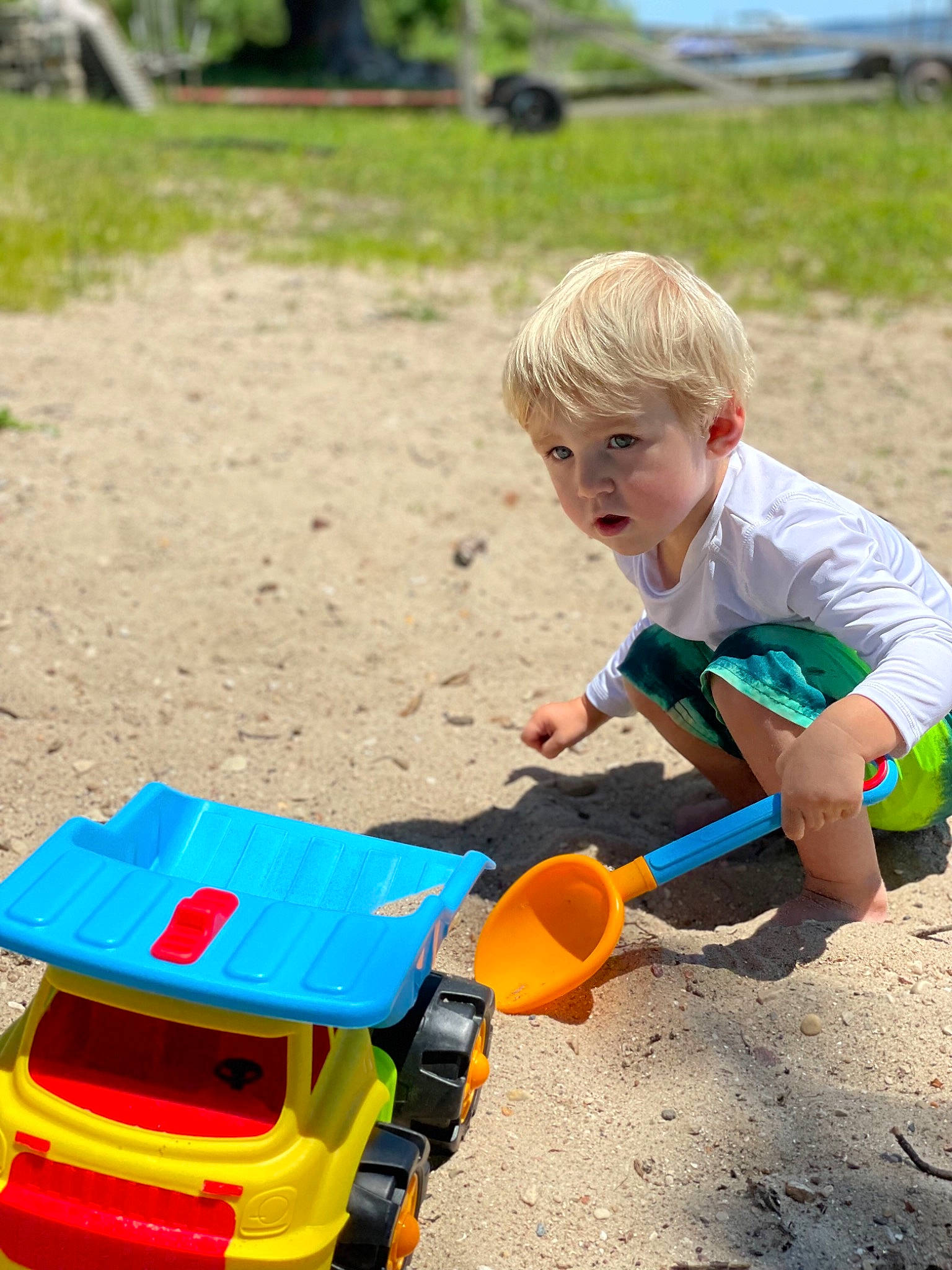 Samuel joined the competition — help win amazing prizes! baby_playing_with_toys, child, fun, grass, leisure, people_in_nature, person, plant, plastic, play, recreation, sand, sitting, sky, soil, summer, t_shirt, toddler, toy, toy_vehicle