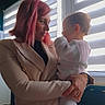 adult, backlight, bracelet, child, coat, embrace, family, gazing, holding, indoor, mother_child, portrait, red_hair, sweater, table, tights, toddler, wicker, window_blinds, woman