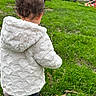 back_of_head, bench, boots, child, curly_hair, daytime, grass, hood, jeans, outdoor, park, person, pink_boots, standing, sticks, toddler, van, vehicle, walking, white_jacket